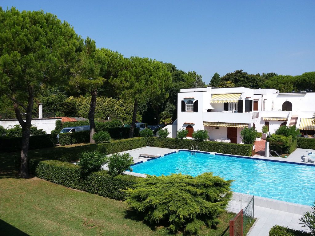 View of the 'Alla Vigna' Residence pool area with surrounding villas.